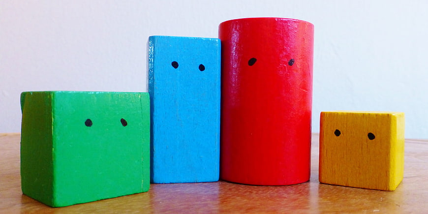 Colorful wooden blocks with faces on table