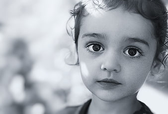Black and white portrait of a young child looking at camera