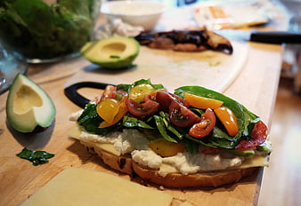 Fresh Caprese Sandwich with Avocado and Tomatoes on Wooden Board
