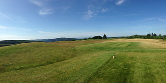 Panoramic View of Rolling Green Hills and Blue Sky