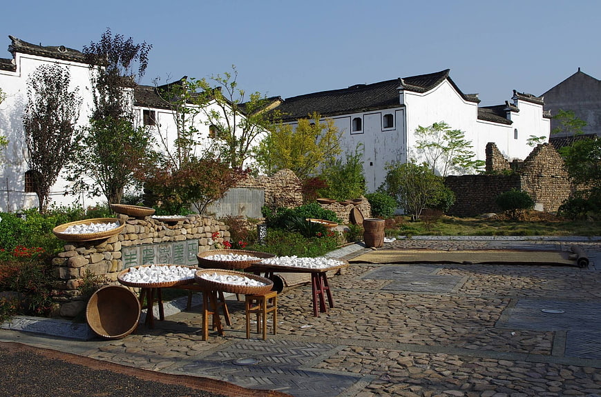 Traditional Chinese Village with White Walls and Drying Baskets