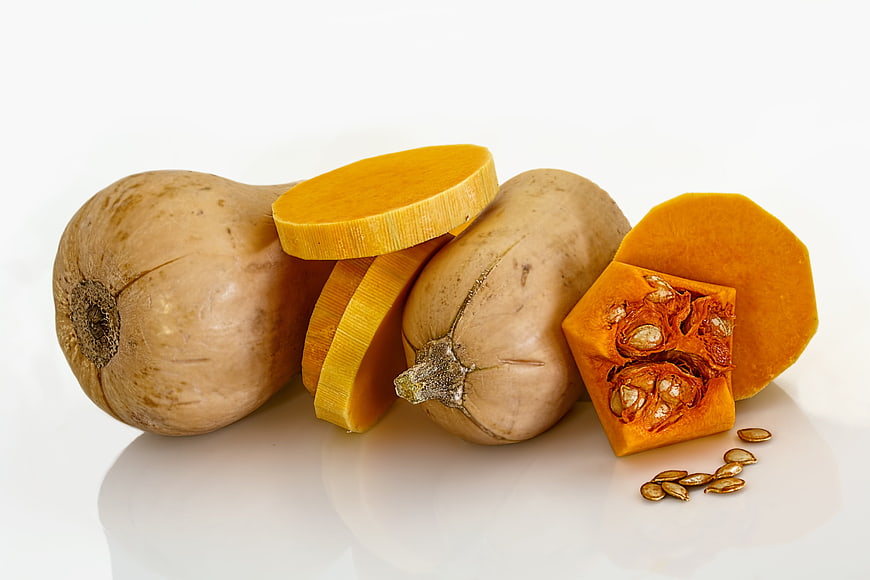 Fresh Butternut Squash With Slices And Seeds On White Background