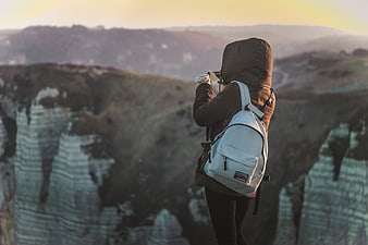 Hiker with Backpack Taking Photo of Mountain Landscape