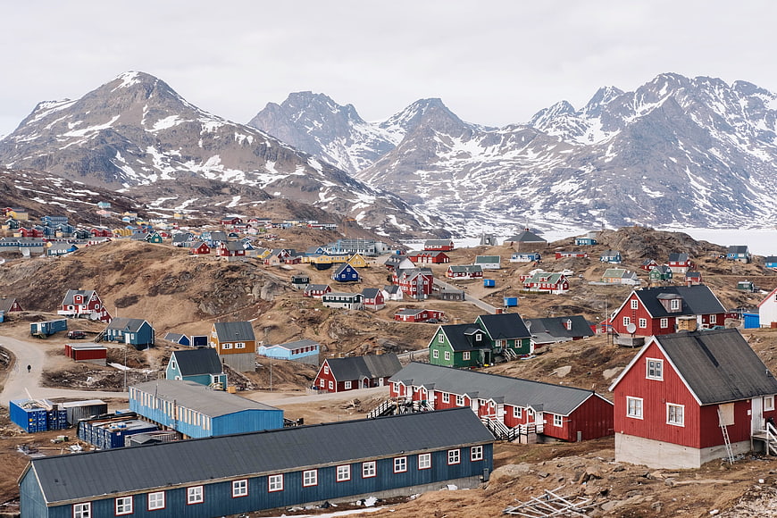 Colorful houses in arctic village with snowy mountains