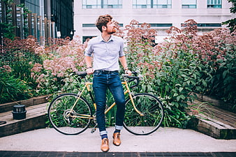 Stylish Man with Yellow Bicycle in Urban Garden