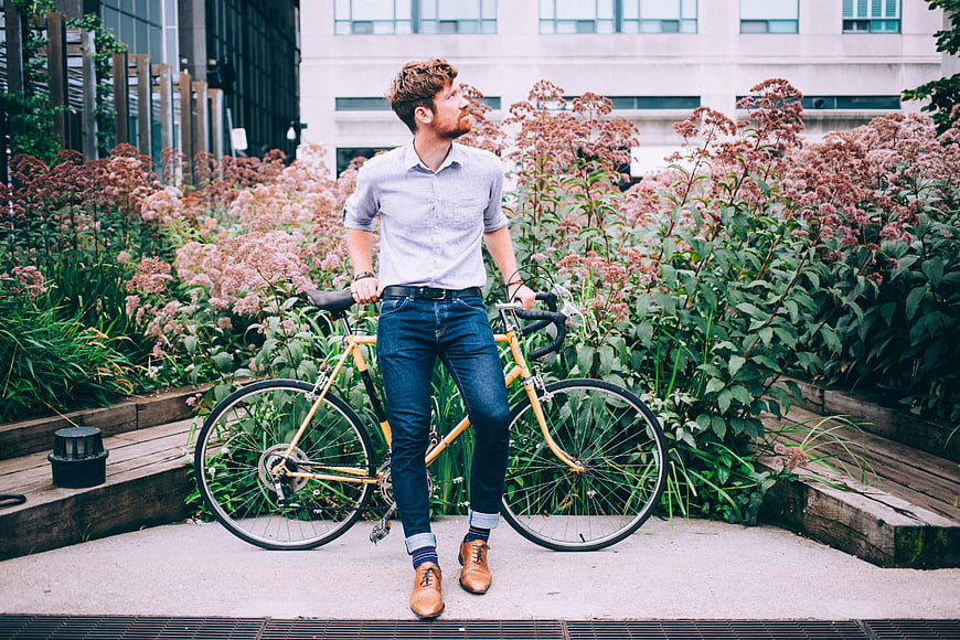 Stylish Man with Yellow Bicycle in Urban Garden