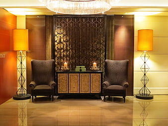 Luxurious hotel lobby interior with symmetrical seating and warm lighting