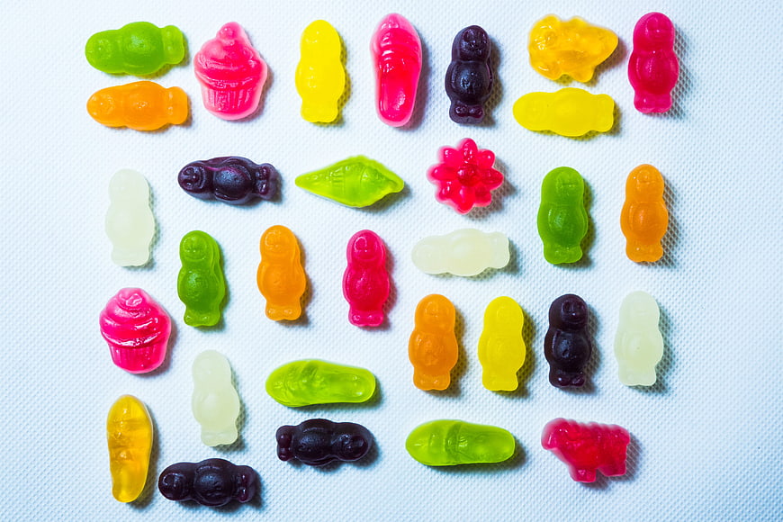 Colorful Gummy Bears and Sweets on White Background