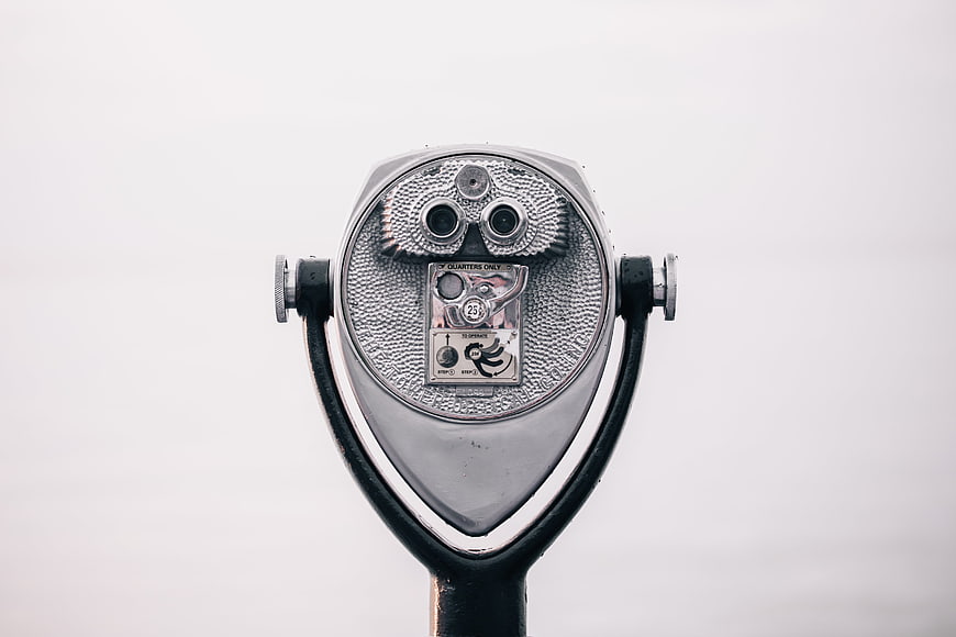 Silver Coin-Operated Binoculars on Overcast Day