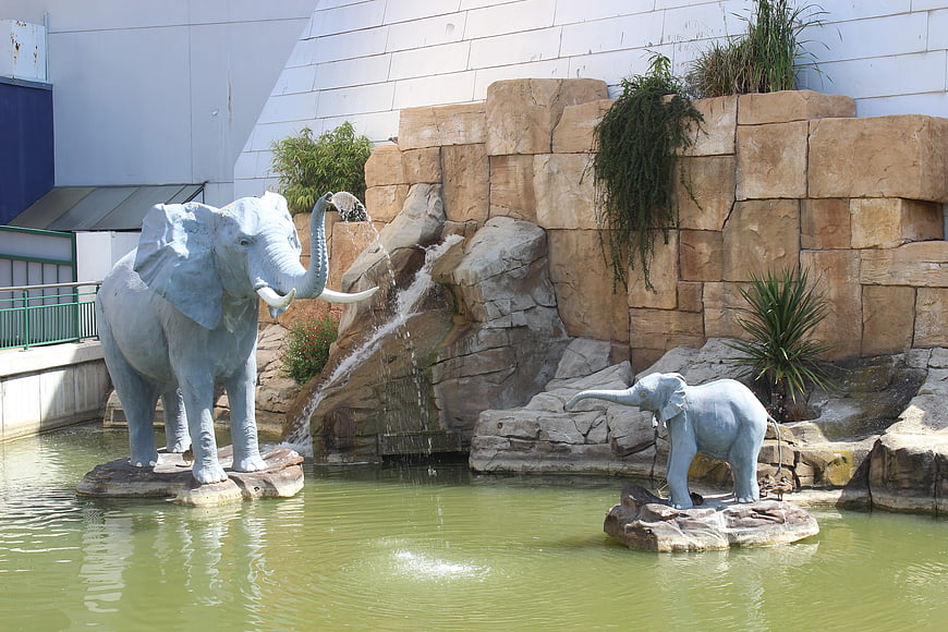 Elephant statues in a water fountain with rock waterfall