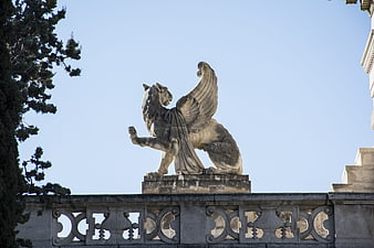 Stone Winged Lion Sculpture on Architectural Balustrade