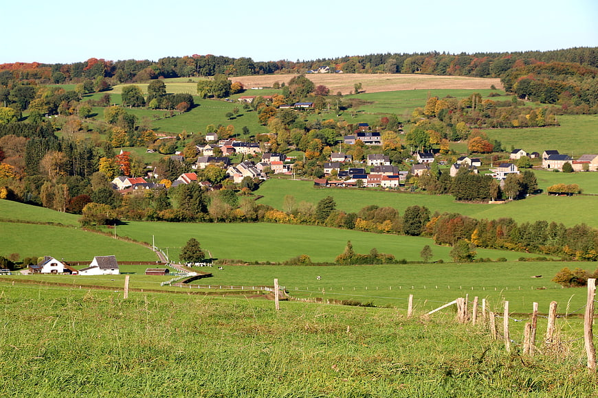 Scenic autumn village nestled in rolling green hills