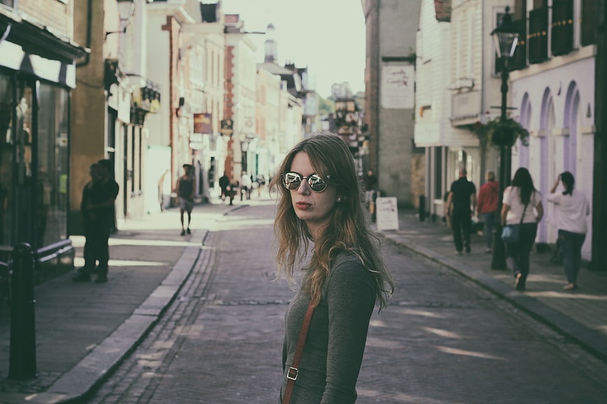 Woman with Sunglasses on Cobblestone Street