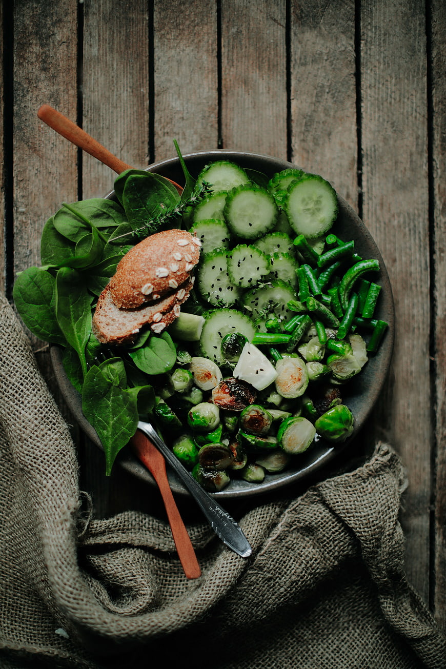 Overhead view of healthy green salad with roasted Brussels sprouts
