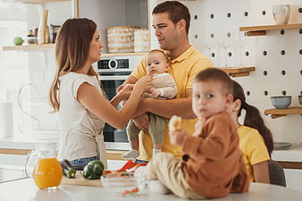 Happy family with children cooking together in modern kitchen