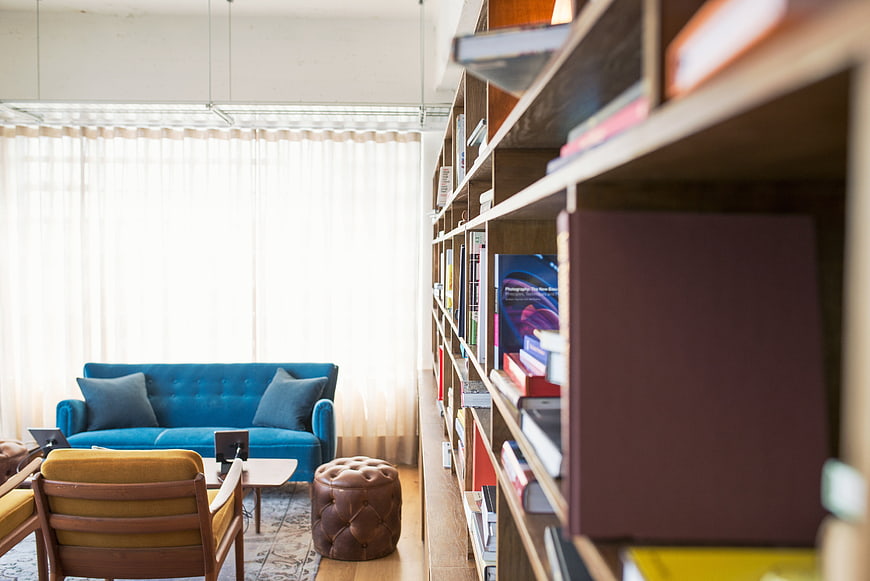 Modern Living Room Interior With Blue Sofa And Bookshelves
