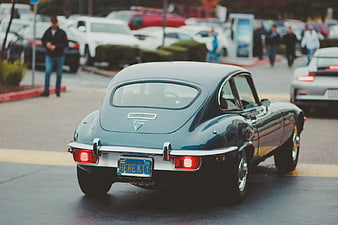 Rear view of classic blue Jaguar E-type on street
