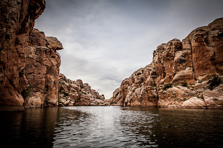 Dramatic Canyon Landscape with Calm Water and Rocky Cliffs