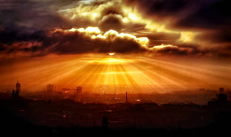 Dramatic Sunset Sunbeams Over Silhouetted City Skyline