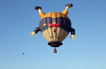 Humpty Dumpty Hot Air Balloon Flying In Blue Sky