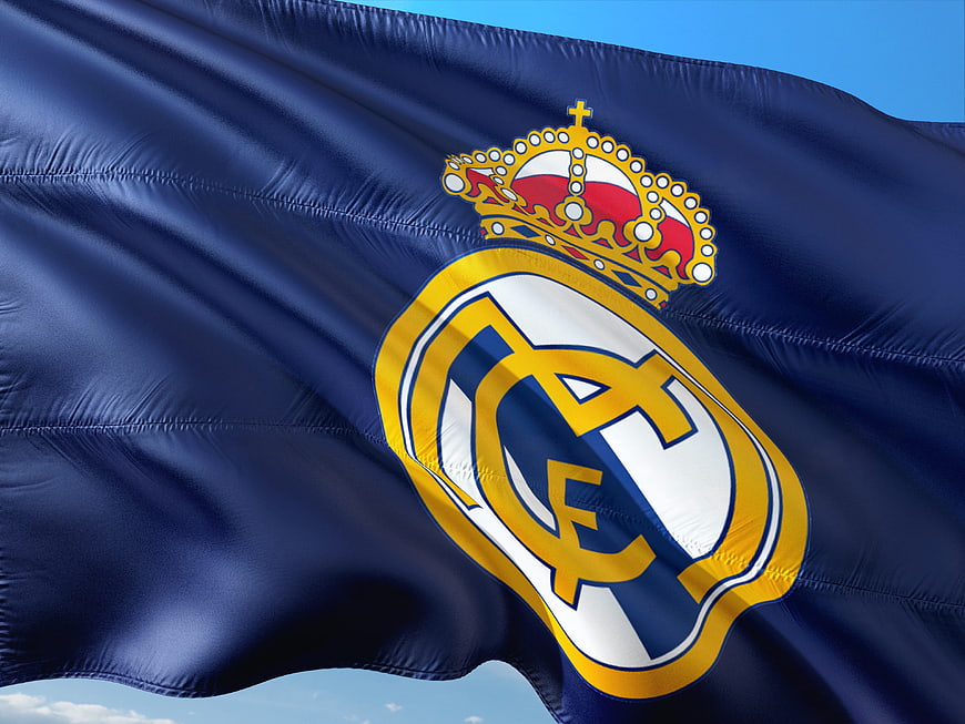 Real Madrid Crest on Blue Flag Waving in Wind