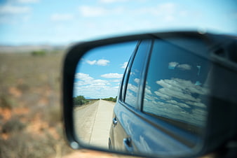 Car Side Mirror Reflection of Road and Sky
