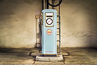 Vintage Shell Gas Pump Against Textured Wall