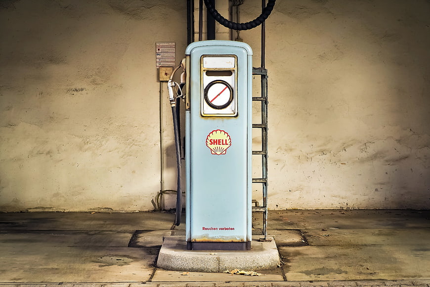 Vintage Shell Gas Pump Against Textured Wall