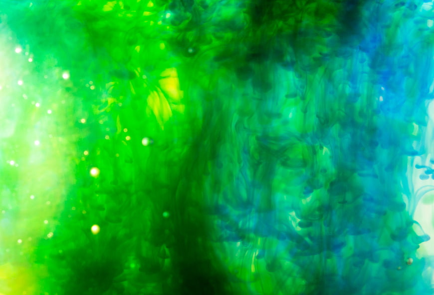 Abstract Green and Blue Ink Swirls in Water