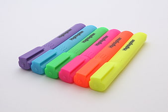 Six Colorful Highlighter Pens Arranged Diagonally On White Background