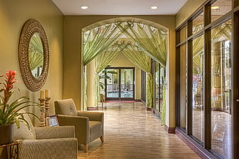 Spa Lobby Interior with Green Drapes and Armchairs