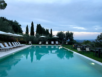 Luxury Resort Swimming Pool at Dusk with Lounge Chairs