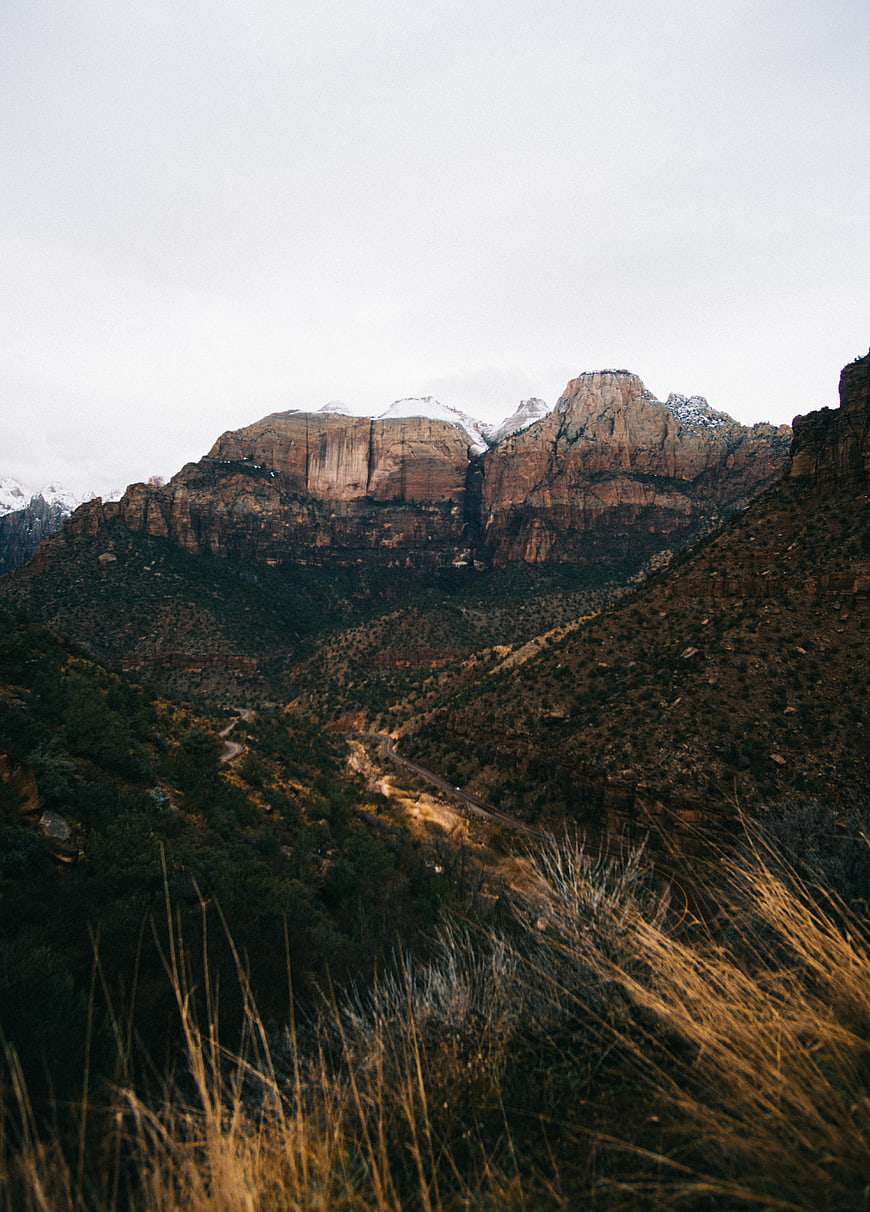 Snow-Capped Red Rock Mountains with Winding Road