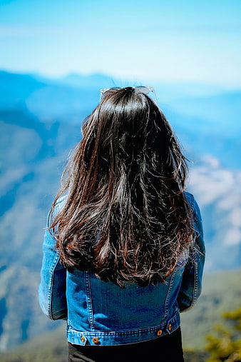 Woman with long hair looking at mountain view