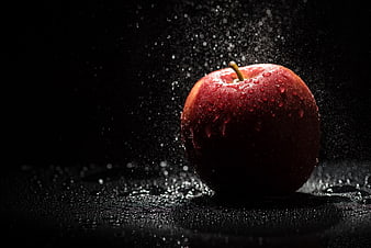 Fresh Red Apple with Water Droplets on Black Background