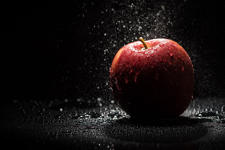 Fresh Red Apple with Water Droplets on Black Background