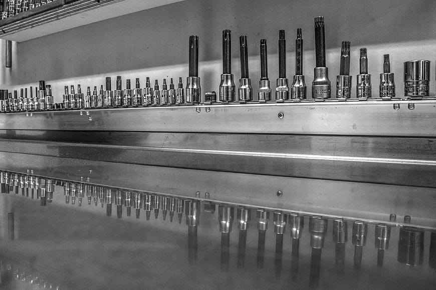 Black and white row of socket wrenches on magnetic strip