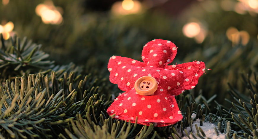 Red Fabric Christmas Angel Ornament on Pine Branch