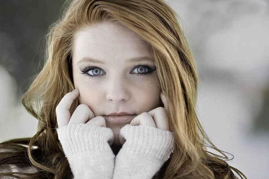Close-up portrait of young redhead woman in winter