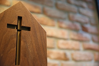 Wooden Cross Cutout on Brick Wall