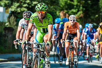 Professional Cyclists Racing on Road in Bright Sunlight