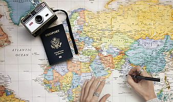Travel planning with vintage camera, passport, and world map