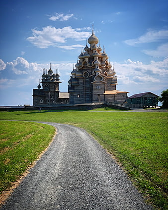 Wooden Russian Orthodox Church with Onion Domes on Grassy Hill