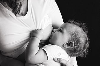 Black and white photo of mother breastfeeding baby