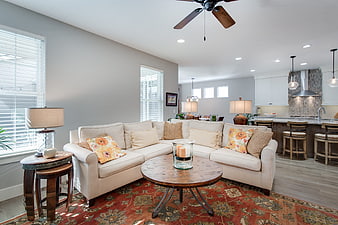 Modern open concept living room with beige sectional and kitchen