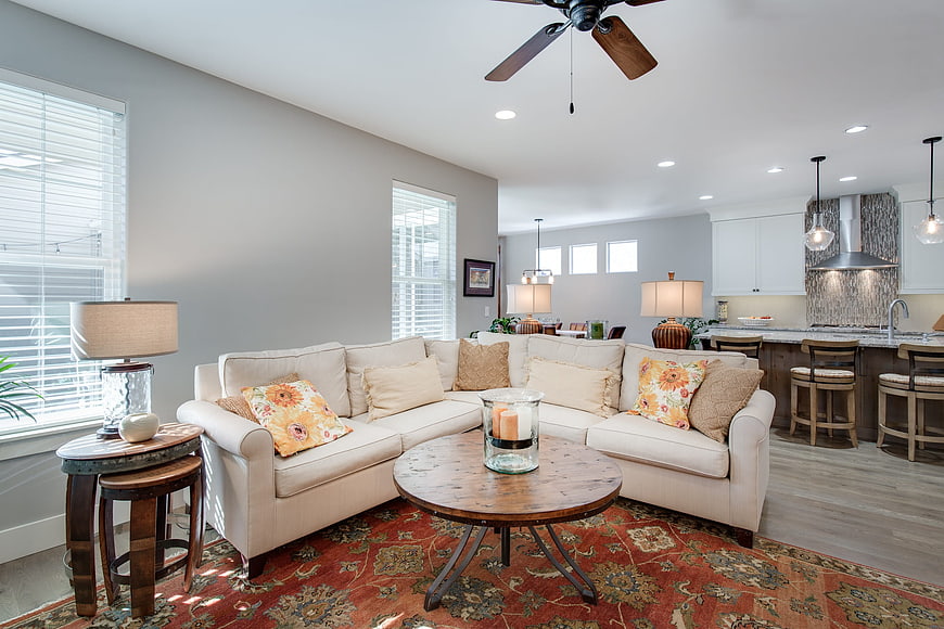 Modern open concept living room with beige sectional and kitchen