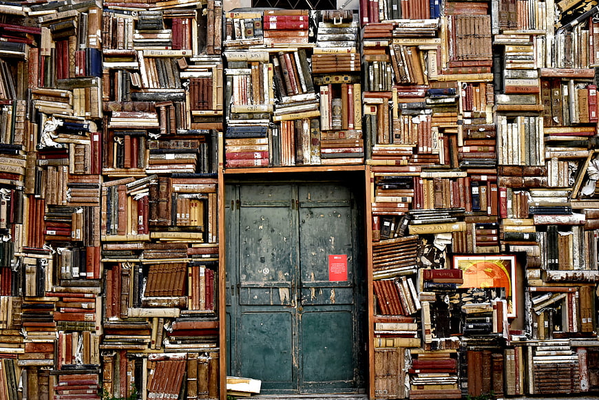 Vintage Books Wall with Green Door Background