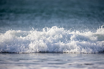 Close-up of crashing ocean wave with white foam and sea spray