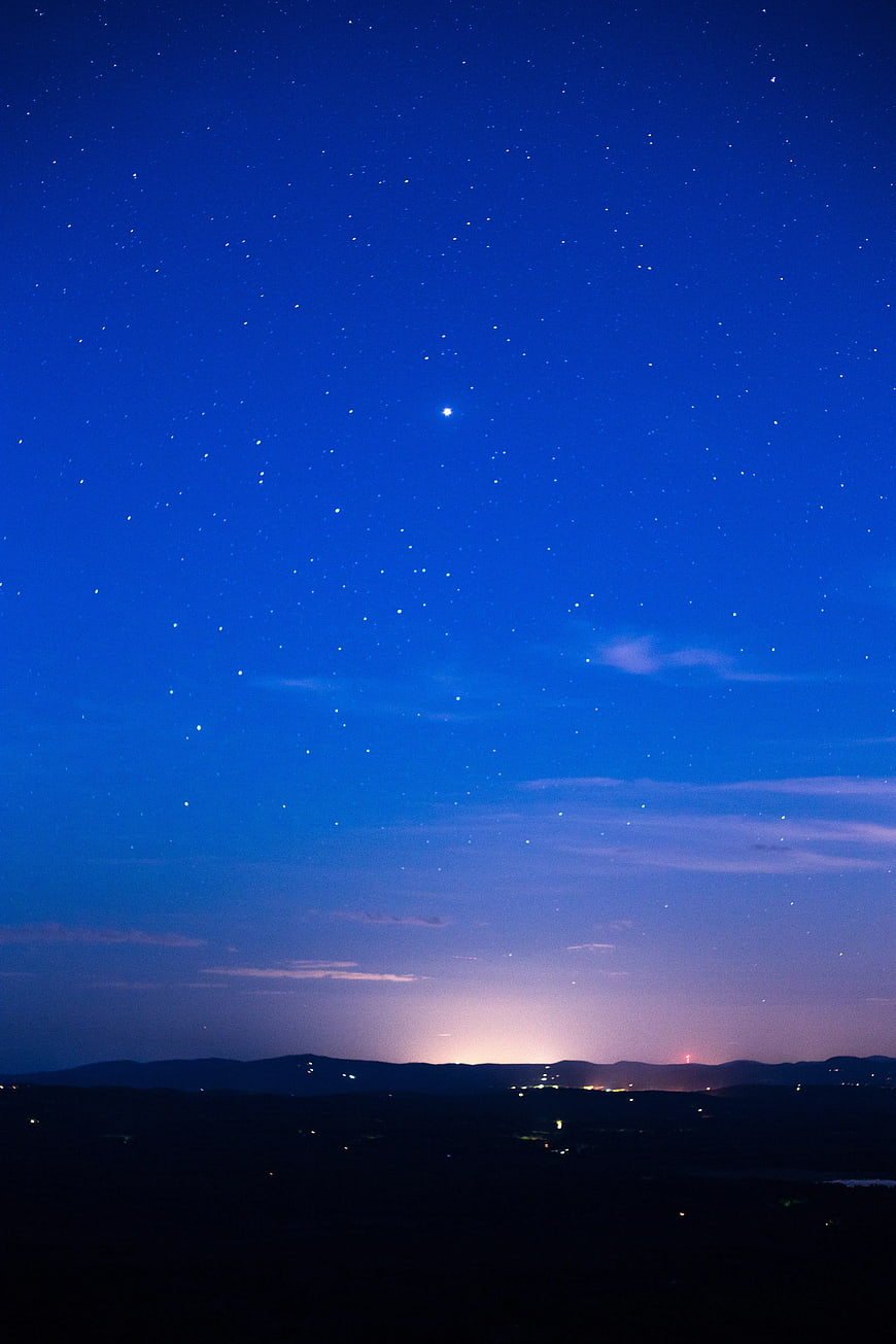 Starry Night Sky Over Mountain Silhouette