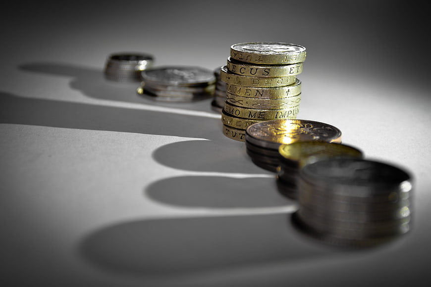 Stacks of Euro Coins on Gray Background with Shadows